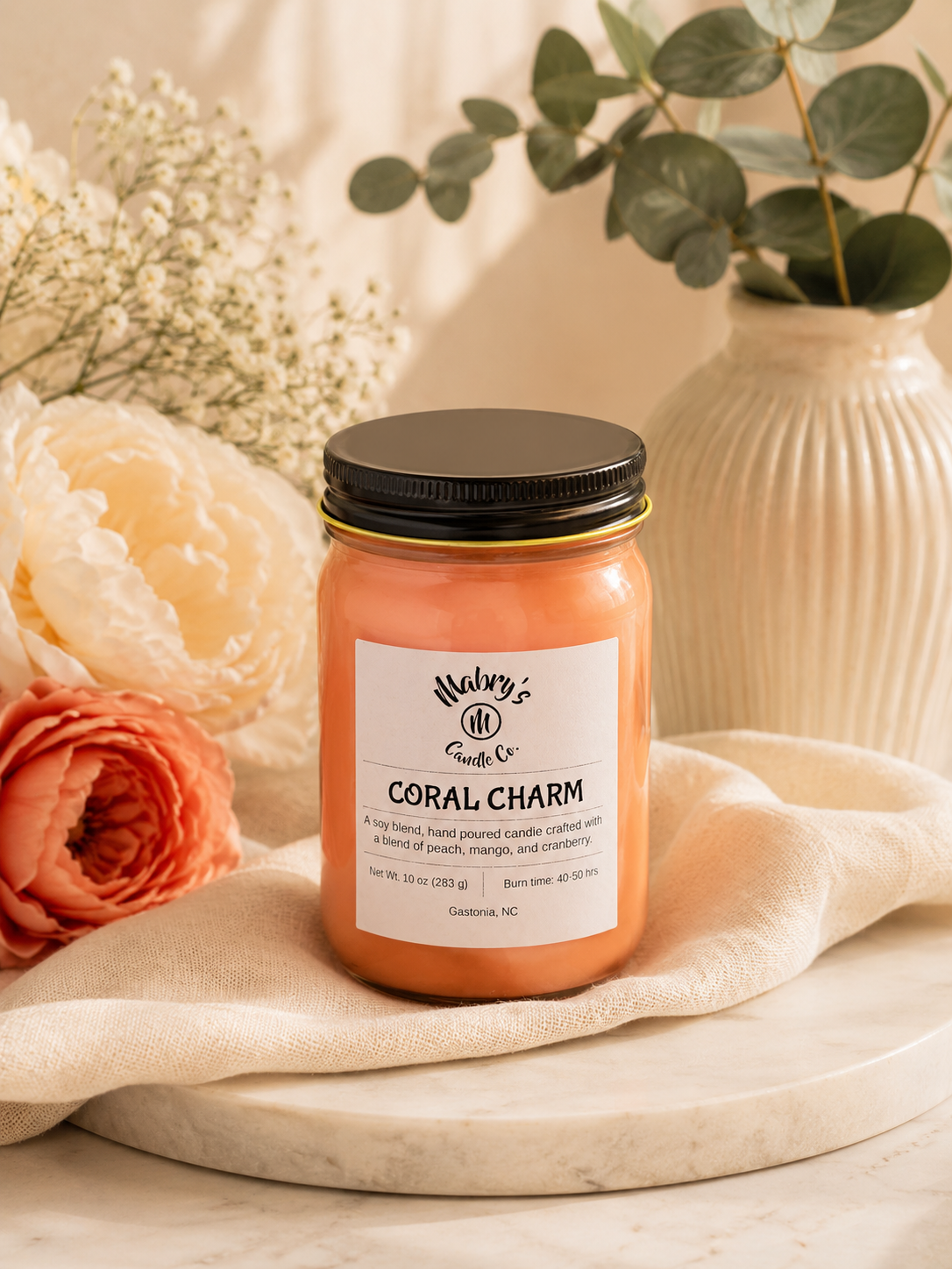 Product photo of a 12 oz canning jar candle in Coral Charm scent