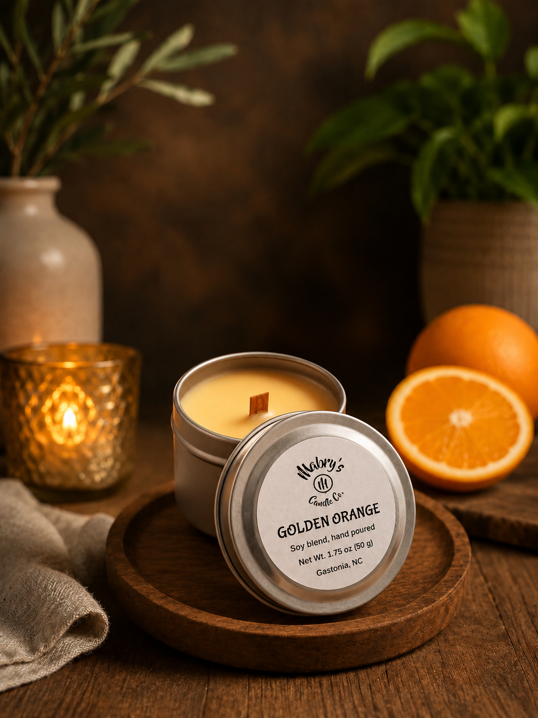Product photo of a 2 oz candle tin in Golden Orange scent