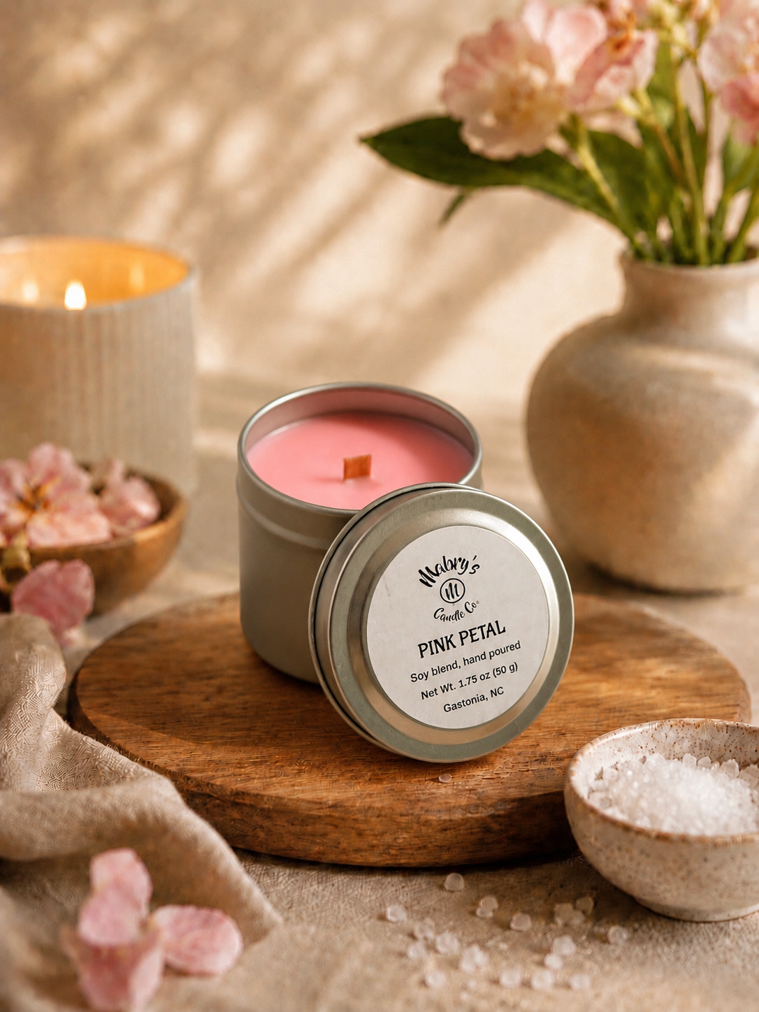 Product photo of a 2 oz candle tin in Pink Petal scent